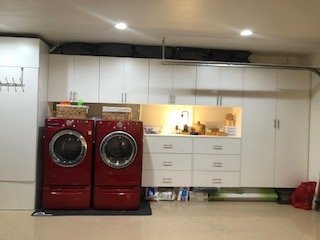 Wide backyard view showing pool with slide, patio, and lush landscaping