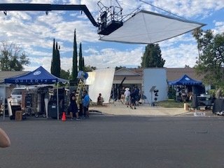 Camera and lighting setup with diffusion frame and production tents